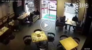 В Китае курьер случайно разбил стеклянную дверь ресторана и остался стоять с металлической ручкой