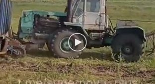 A Ukrainian farmer clears his field of mines using a radio-controlled tractor with a makeshift trawl