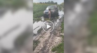 Three beautiful girls stuck in a jeep in the mud