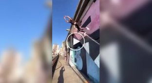 A girl jumped in a dress from a bridge into a river