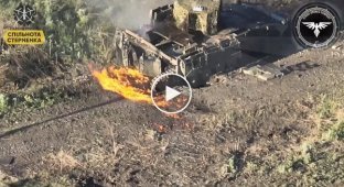 An enemy infantry fighting vehicle that runs over a mine is set on fire by a kamikaze drone