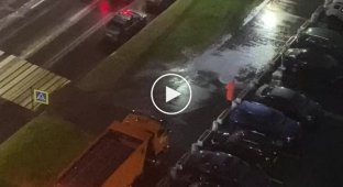 St. Petersburg public utilities wash the asphalt in the pouring rain