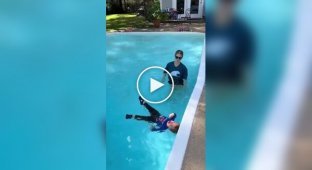 Coach teaches boy to swim