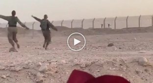 Egyptian and Israeli soldiers dance on both sides of the border