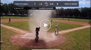 At baseball, the referee saved a boy who got caught in a dust whirlwind