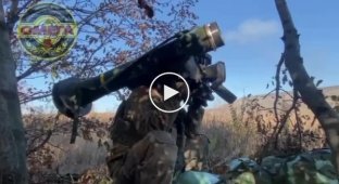 A Ukrainian soldier hits a Russian infantry fighting vehicle using a Javelin anti-tank missile system in the Avdeevka area of the Donetsk region