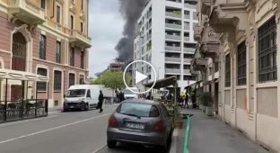 A powerful explosion in the center of Milan - cars are burning, pillars of smoke rise above the houses