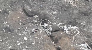 An occupier flies over a trench after a Ukrainian drone strike