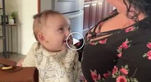 Give. The baby looks with appetite at the breasts of his mother's friend
