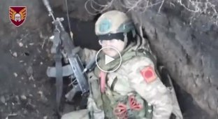 A liquidated Russian invader burns in a trench in the Donetsk region