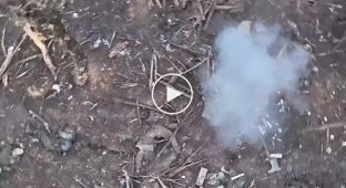 An occupier's leg and helmet fly in the air after a grenade is dropped from a Ukrainian drone