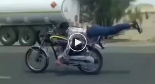 Attentive motorcyclists show tricks