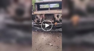 The occupier films a Russian army truck burned by a Ukrainian drone and a pile of remains of its driver