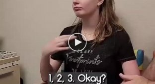 A girl gets her hearing aid turned on for the first time.