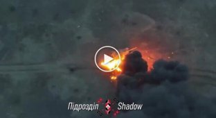 Two Russian armored vehicles are on fire on the battlefield