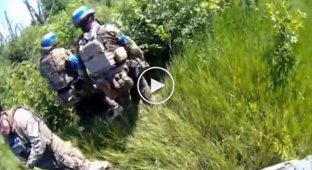 Ukrainian military evacuate a wounded comrade under mortar fire near Bakhmut