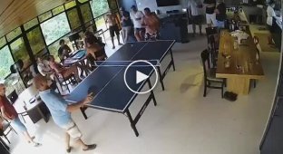 A man broke a ping pong table while trying to beat his opponent.
