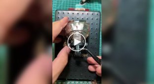 A Vietnamese craftsman assembles figurines from lighter parts