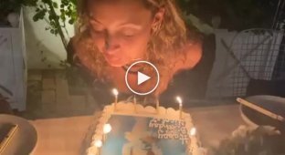 Блондинка задувает свечи на торте