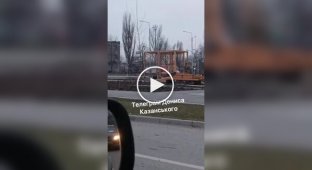 A Russian military truck marked Z lies upside down on the sidewalk in occupied Lugansk.