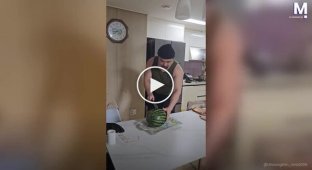 An attempt to effectively cut a watermelon ends in damage to the kitchen table