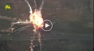 Soldiers of the 60th Separate Motorized Brigade observe the detonation of a tank's ammunition from a drone