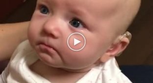 A baby almost deaf from birth hears her mother's voice for the first time
