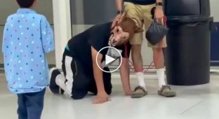A man in a wolf mask was led around the airport on a leash