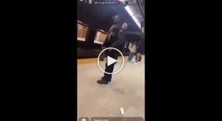 A black man does an acrobatic number in the subway