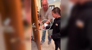 Grandfather pulls out baby tooth for granddaughter