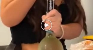 Girl trying to open a bottle with a corkscrew