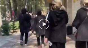 Women walk around the capital of Iran without a hijab