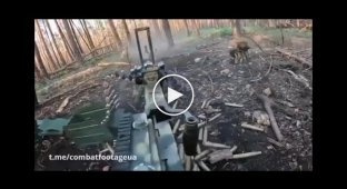 A Ukrainian soldier suppresses enemy positions with a DShK heavy machine gun during a battle in the Kremensky forest