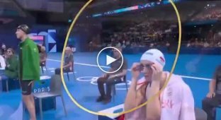 A man in bright swimming trunks burst into the women's Olympic swim for the sake of a cap