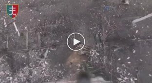 A Russian soldier kicks a grenade dropped from a drone in the Kherson region