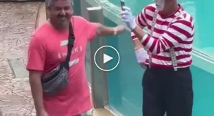 Cheerful mime played a joke on a tourist