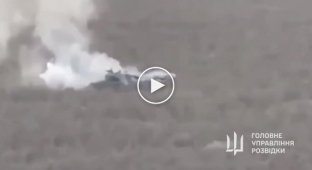 A smoking tank in a field and then a great explosion