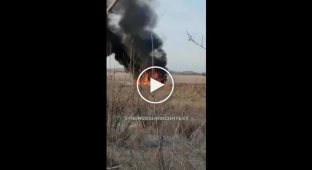 An occupier looks from the bushes at a burning Russian car and curses Ukrainians