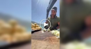 A man prepared food in an excavator bucket