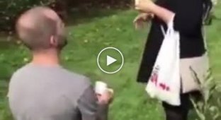The girl responded to the marriage proposal by throwing an apple at the guy's head