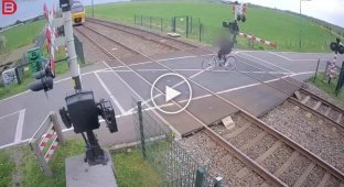 A cyclist narrowly escaped being hit by a train