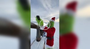 Engineer cosplays the Grinch on a jet sled