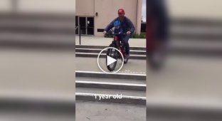 A father-cyclist teaches his one-year-old son to ride a bike