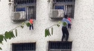 Китаец спас малыша, застрявшего головой в оконной решётке (3 фото + 1 видео)