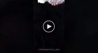 A Ukrainian soldier escorts two captured occupiers near Chasov Yar