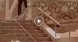 Unsuccessful descent of the skateboarder on the railing of the stairs