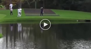 Golfer Jon Rahm launches a ball