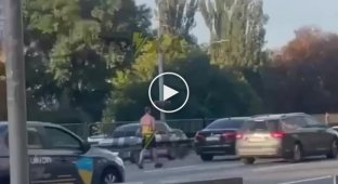A man masturbates on a BMW in the middle of the road in Kyiv