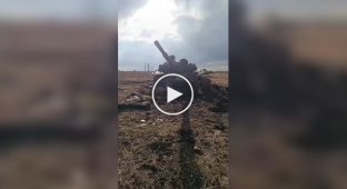 A Russian soldier inspects his broken convoy of armored vehicles in the Donetsk region