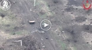 An occupant tries to shoot down a kamikaze drone by throwing a stone at it